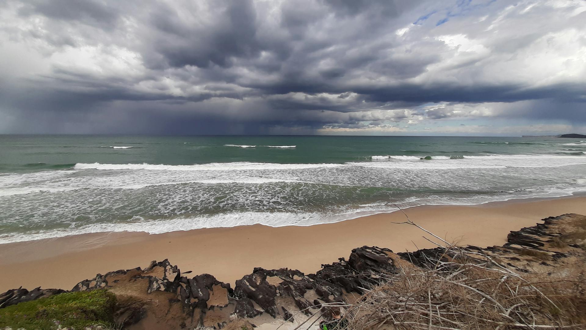 Stormy clouds and waves at Port Macquarie beach in NSW, Australia.