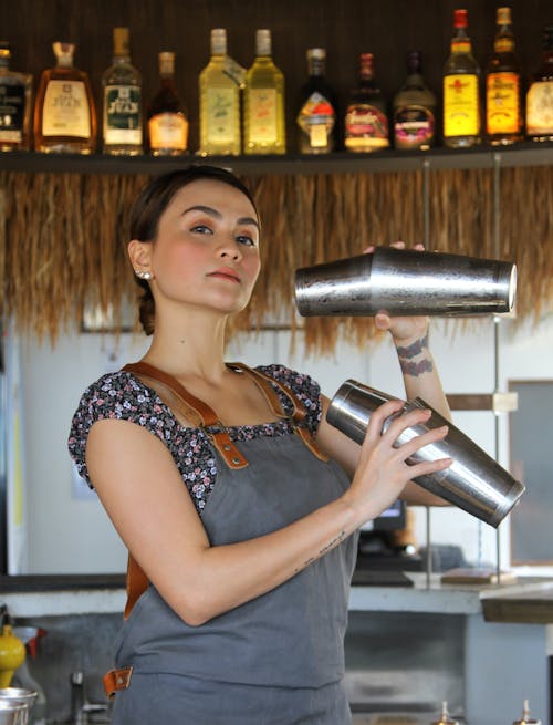A Woman Holding Stainless Shakers