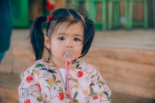 Girl Wearing White, Red, and Yellow Floral Top