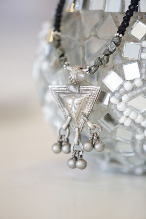 Free Close-up of a silver necklace featuring a geometric pendant with intricate details. Stock Photo
