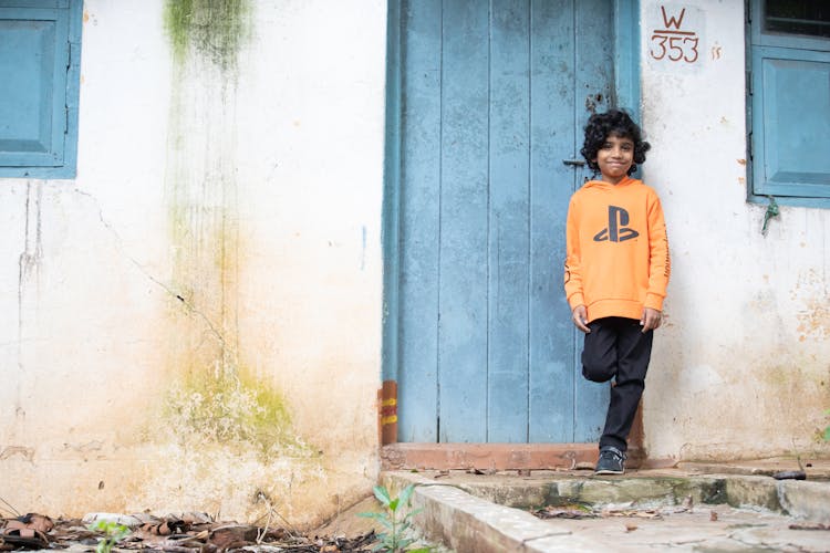 A Boy Standing Near The Door