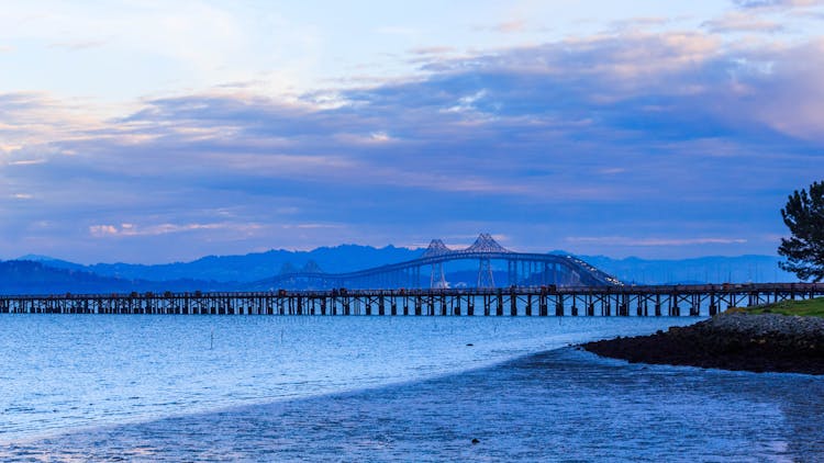 Wooden Dock In The Sea And High Way Bridge