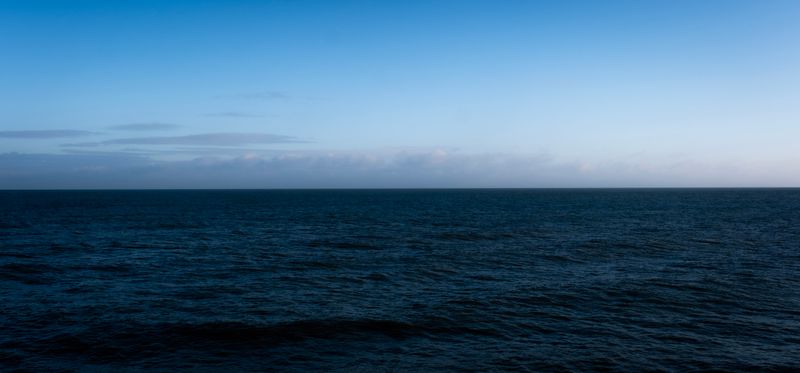Tranquil ocean under a twilight sky — photo by Mathias Reding on Pexels