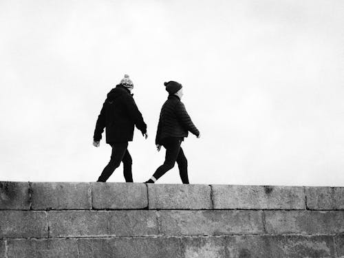 Free Black and White of a Man and Woman Walking Together Stock Photo