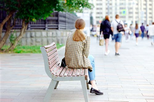 Woman Sitting on a Bench in the Sideway