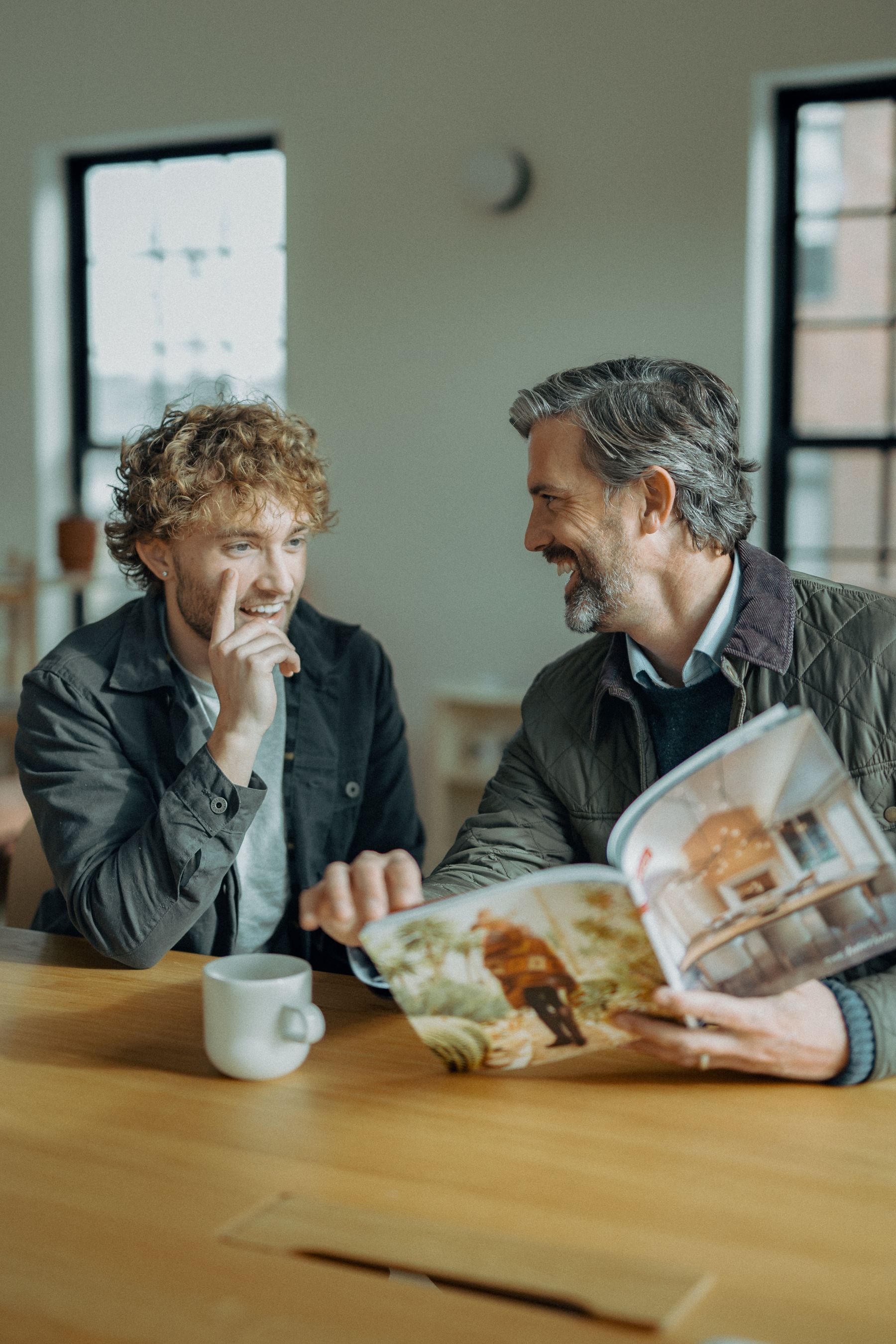 Two gentlemen having a supportive conversation in a comfortable home setting