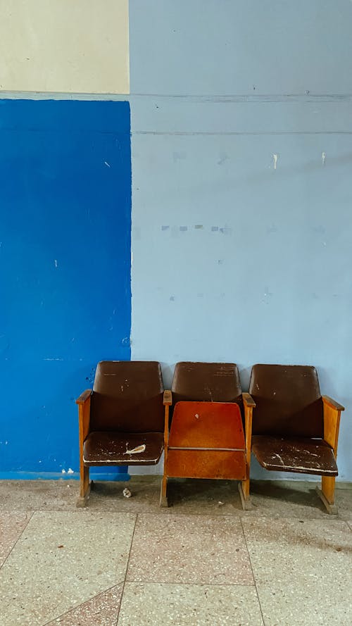Brown Wooden Chairs Beside Blue Wall