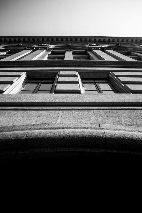Free Dramatic low angle shot of a monochrome building facade with intricate window details. Stock Photo