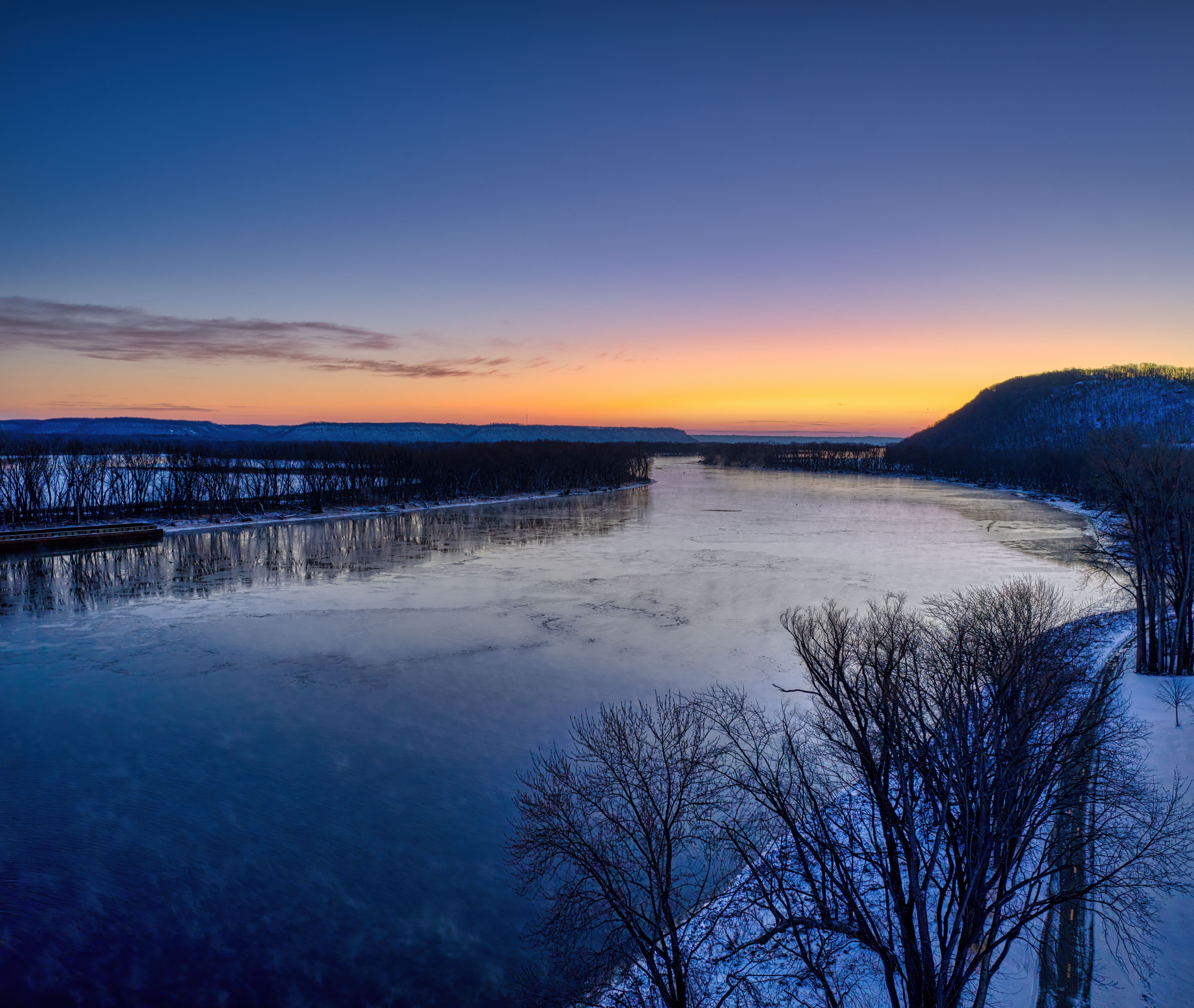 Stunning winter sunrise over a frozen river in Red Wing, Minnesota, capturing serene natural beauty.