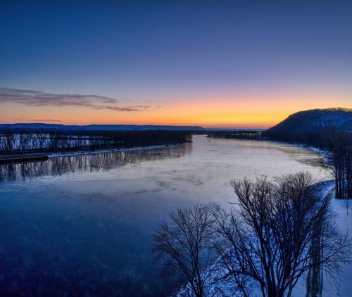 Free Stunning winter sunrise over a frozen river in Red Wing, Minnesota, capturing serene natural beauty. Stock Photo