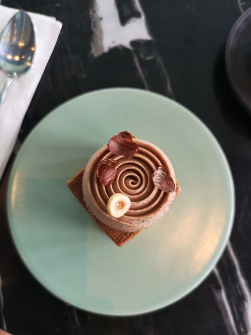 Free Delicious chocolate mousse dessert with decorative toppings on a ceramic plate. Stock Photo