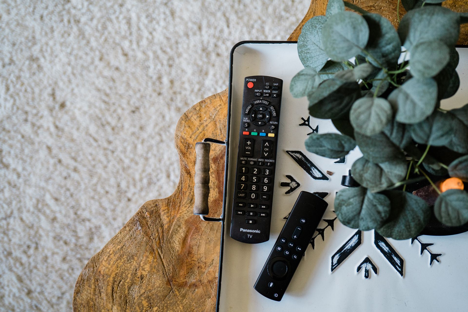 Black Remote Controls on Brown Wooden Table