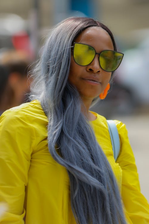 A Woman with Gray Hair and Wearing Yellow Sunglasses