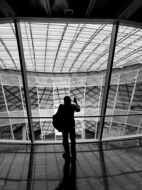 Man in Standing in Front of Glass Wall