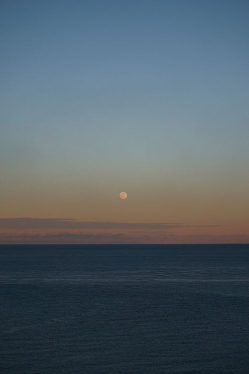 Free Peaceful twilight scene over the sea with the moon in view, captured in Turkey. Stock Photo