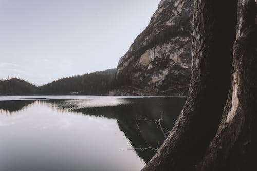 Landscape Photography of Lake Beside Cliff at Daytime