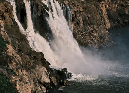Free Stunning waterfall plunging over rugged cliffs into a misty pool below, capturing nature's raw power. Stock Photo