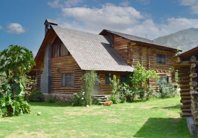 A log home on a wide green lawn. Photo by Cesar Gonzales on Pexels.