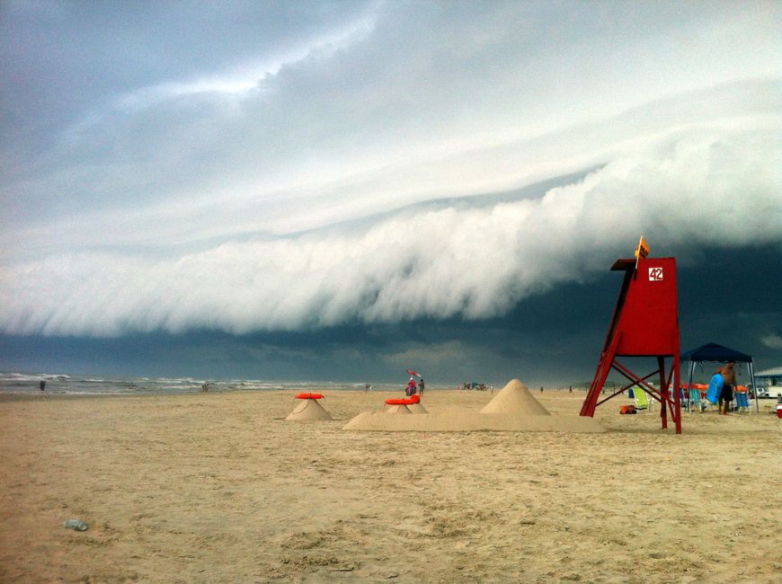 Dramatic cloud formation over Arroio do Sal, Brazil beach with lifeguard stand in view.