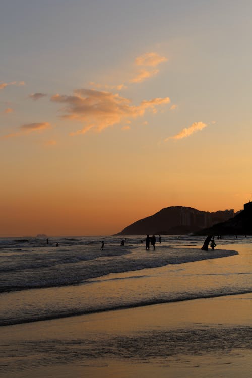 People on Beach during Sunset