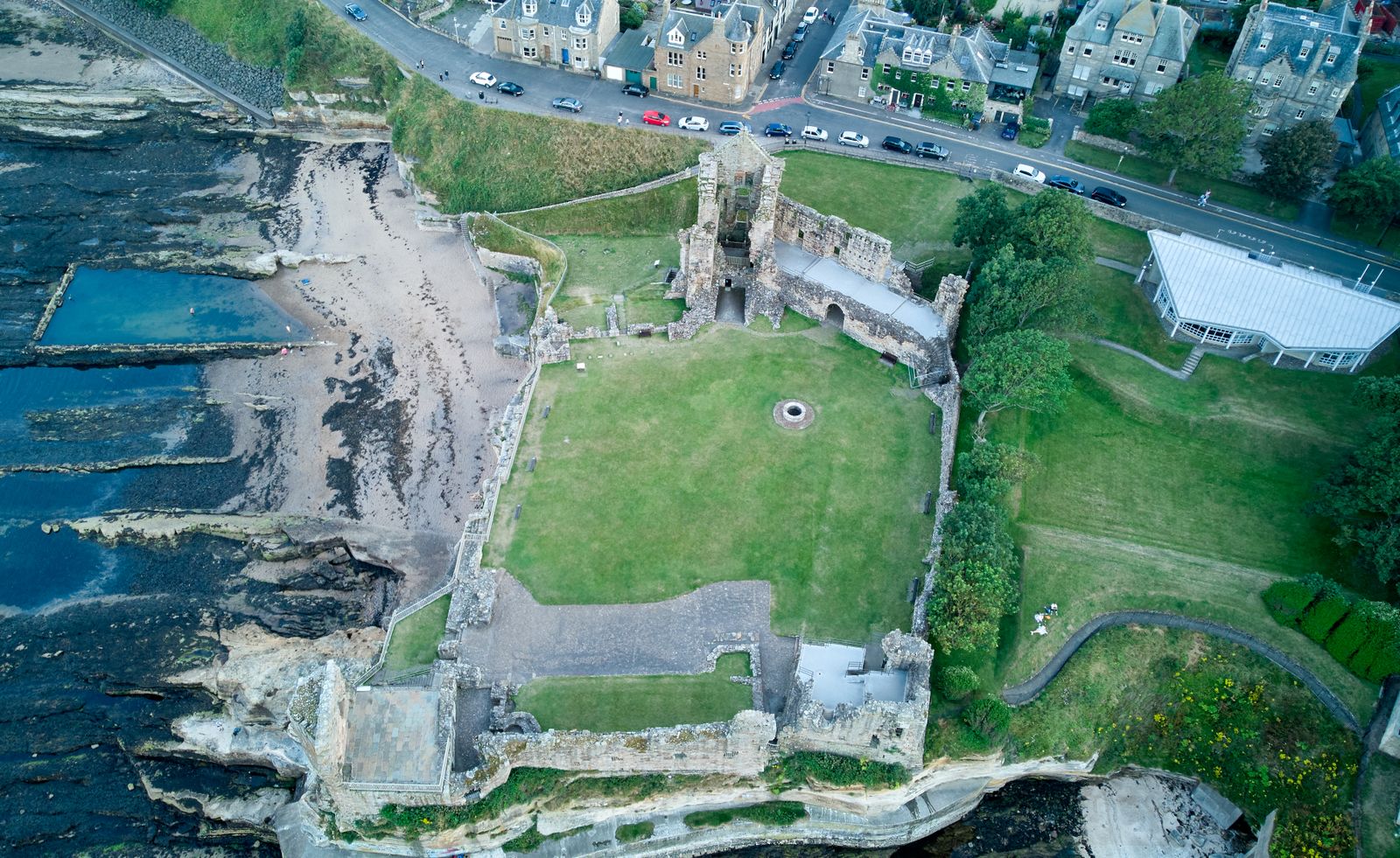 Aerial view of St Andrews Castle ruins on the cliffs beside the sea and the town