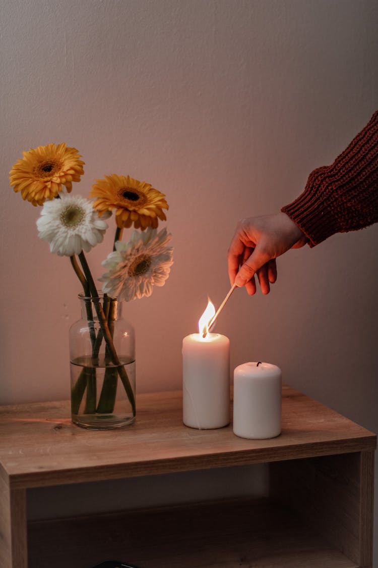 Woman Lighting A Candle