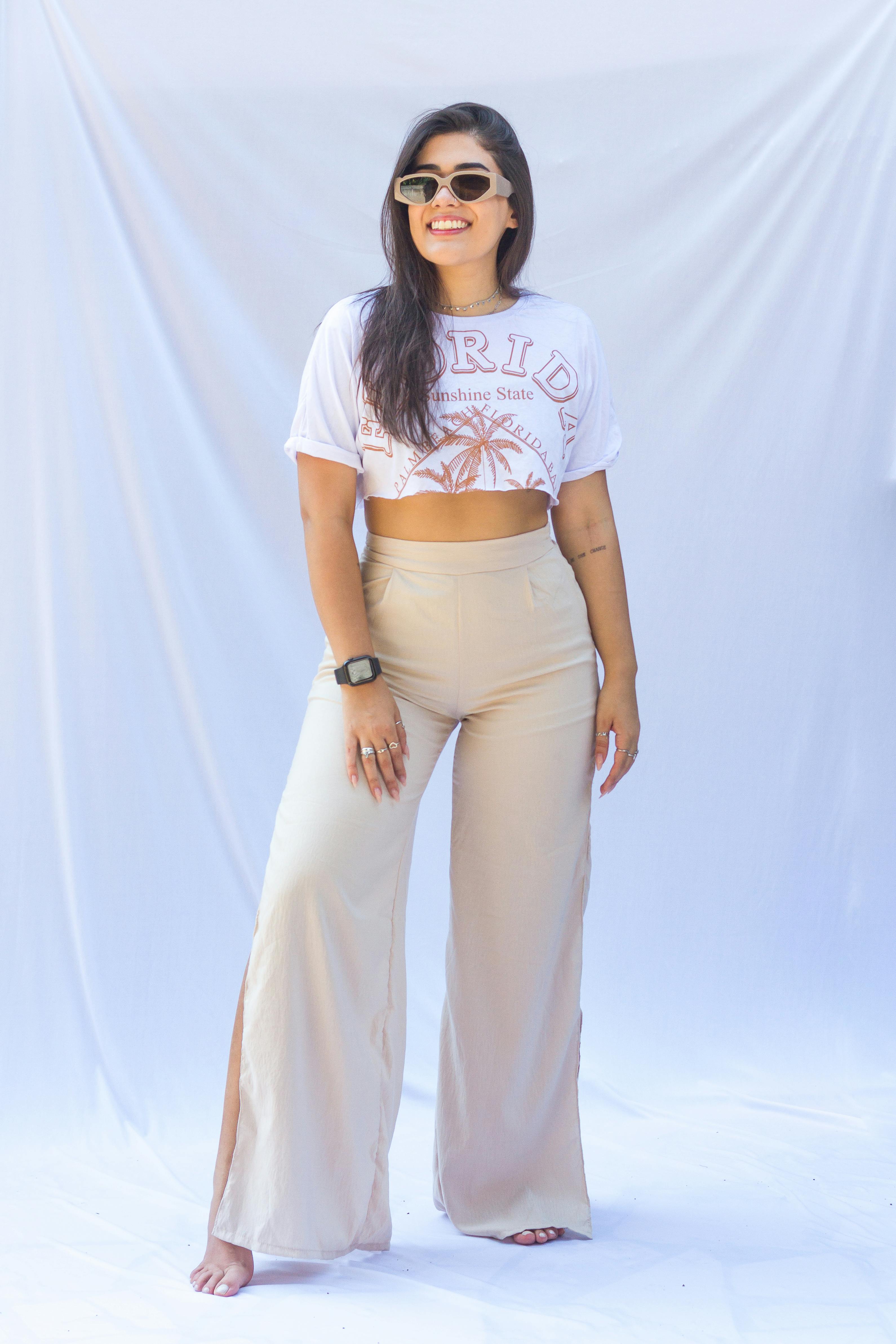 Young Brunette Woman in Black Mesh Crop Top Posing by a Wall · Free Stock  Photo