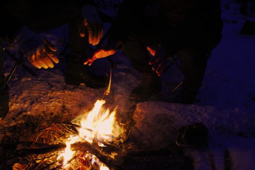 Free Warming hands by a campfire on a snowy night in Balıkesir, Turkey. Stock Photo