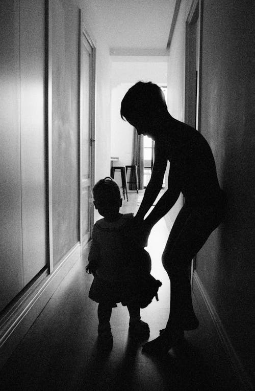 Free 
A Grayscale of Siblings in the Hallway Stock Photo