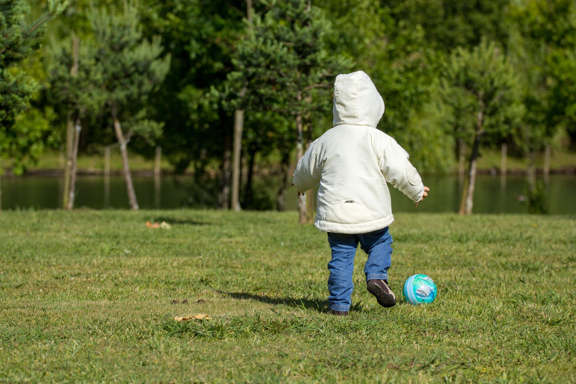 A young child enjoying a football session in Whitefield