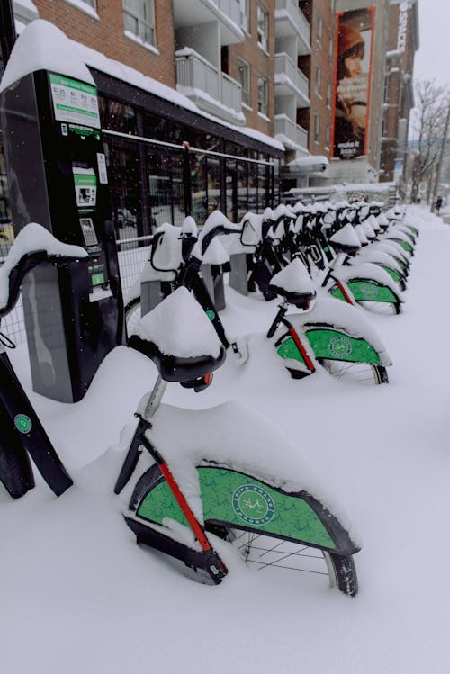 Green and Black Bicycles on Snow Covered Road