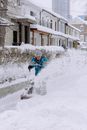 Elderly Man Using Snowblower