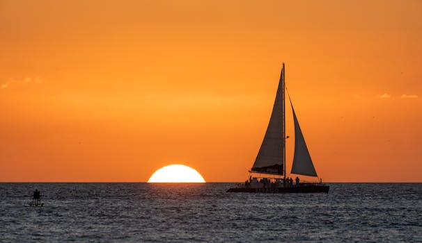 Stunning sunset with sailboat over the ocean horizon in Key West, Florida.