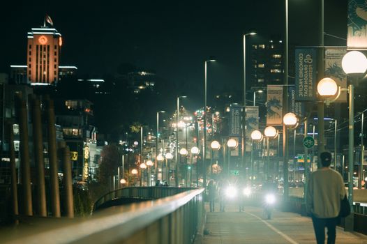 Vibrant night scene of a busy street in Vancouver, BC.