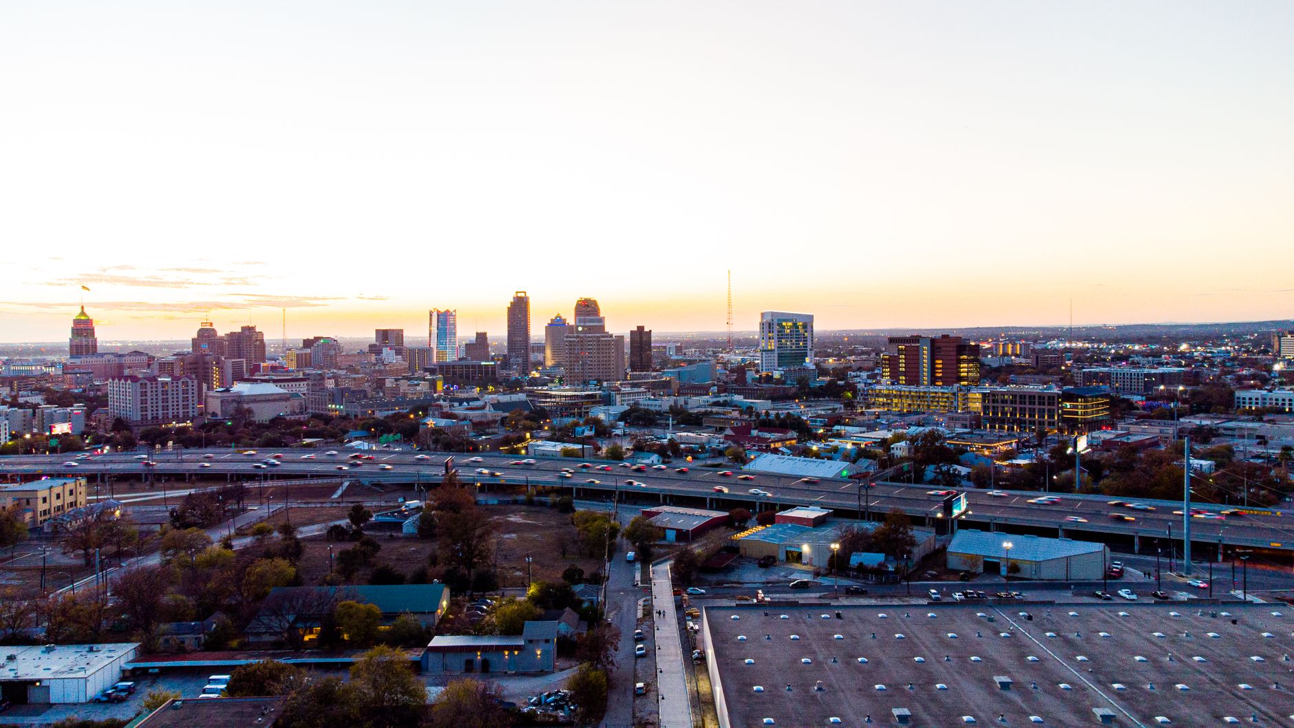 A breathtaking aerial view of San Antonio's skyline during sunset, showcasing its urban charm and high-rise buildings.