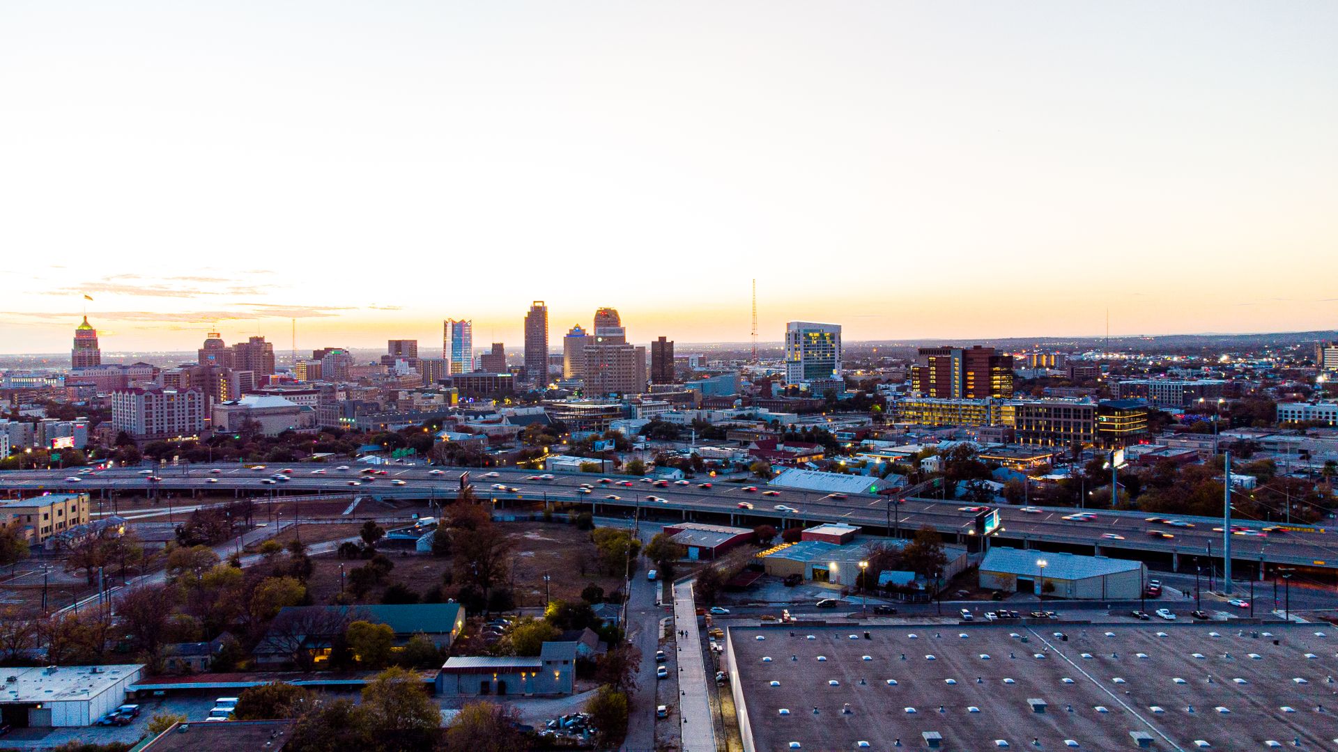 A breathtaking aerial view of San Antonio's skyline during sunset, showcasing its urban charm and high-rise buildings.