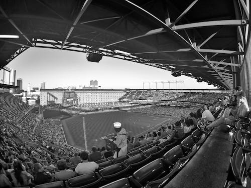 Free Grayscale Photo of People Sitting on Stadium Seats Stock Photo