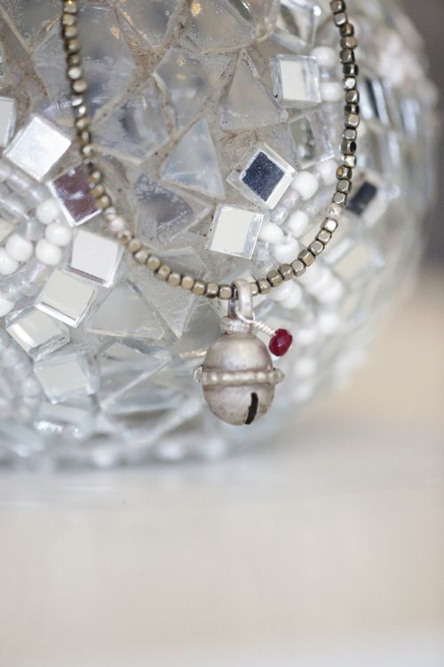 Free Close-up of a vintage bell pendant resting on a mirrored, decorative surface. Stock Photo