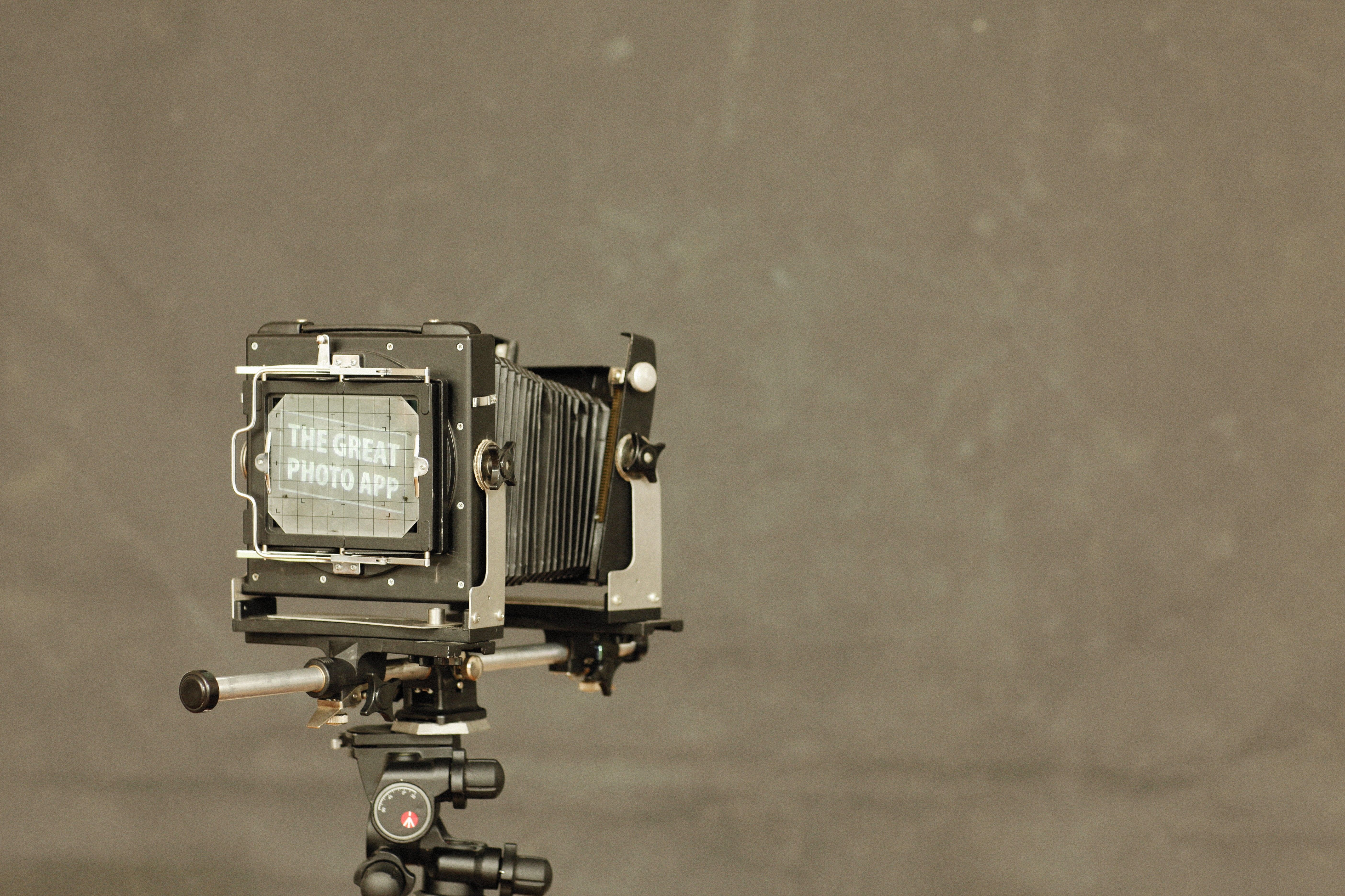 A close-up of a classic vintage camera on a tripod, exuding retro charm and nostalgia.