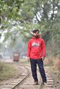 Man in Red Hoodie Standing on the Railway