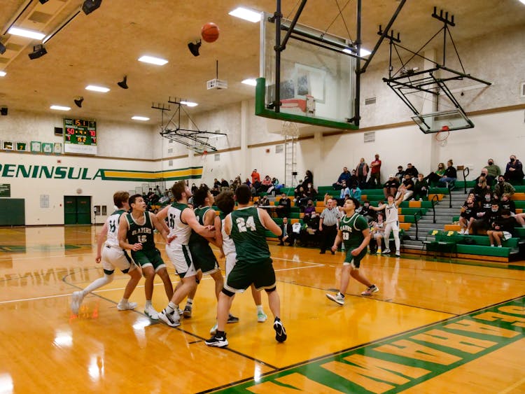 Men Playing The Game Of Basketball