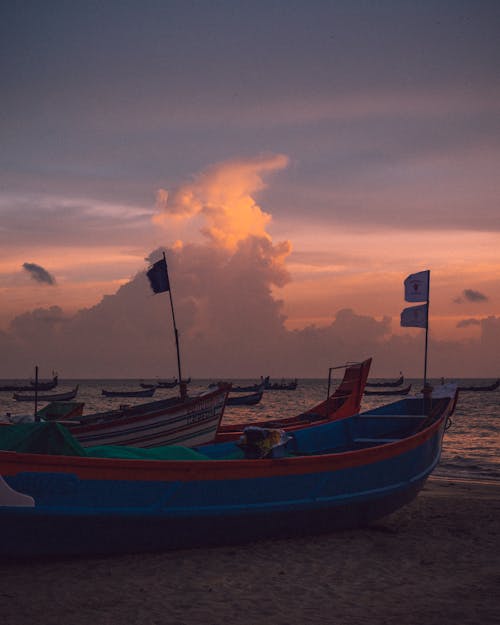 Free Fishing Boats on the Sea Shore during Sunset Stock Photo