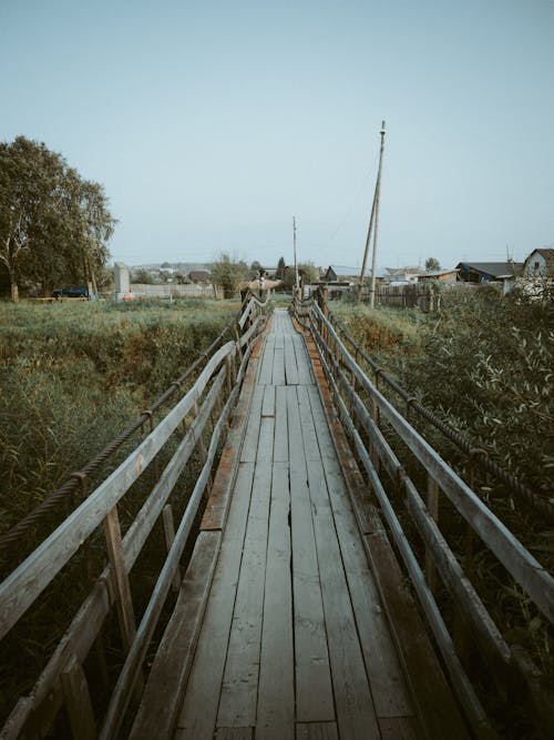 Wooden Bridge over Green Grass Field