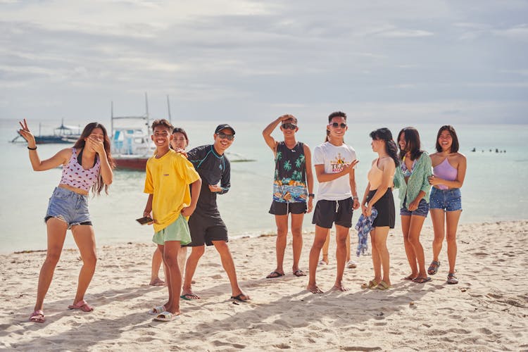 Group Of People Standing On Beach 