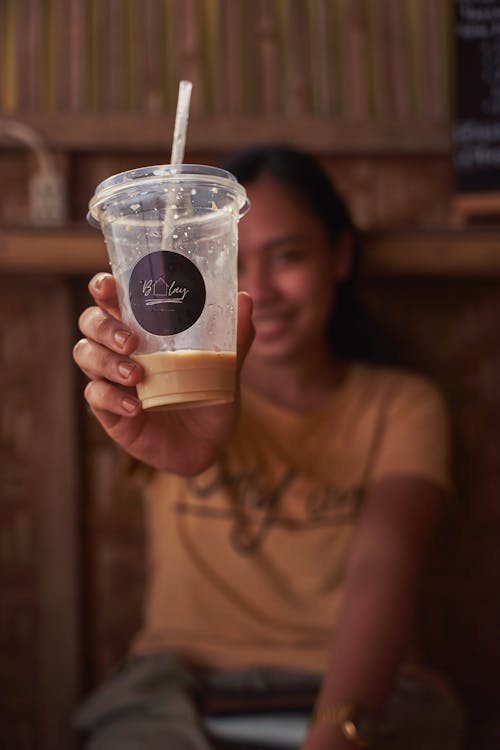 Free A Woman Holding a Cup of Milk Tea Stock Photo