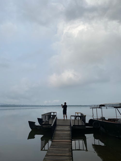 Man Standing at a Wooden Dock