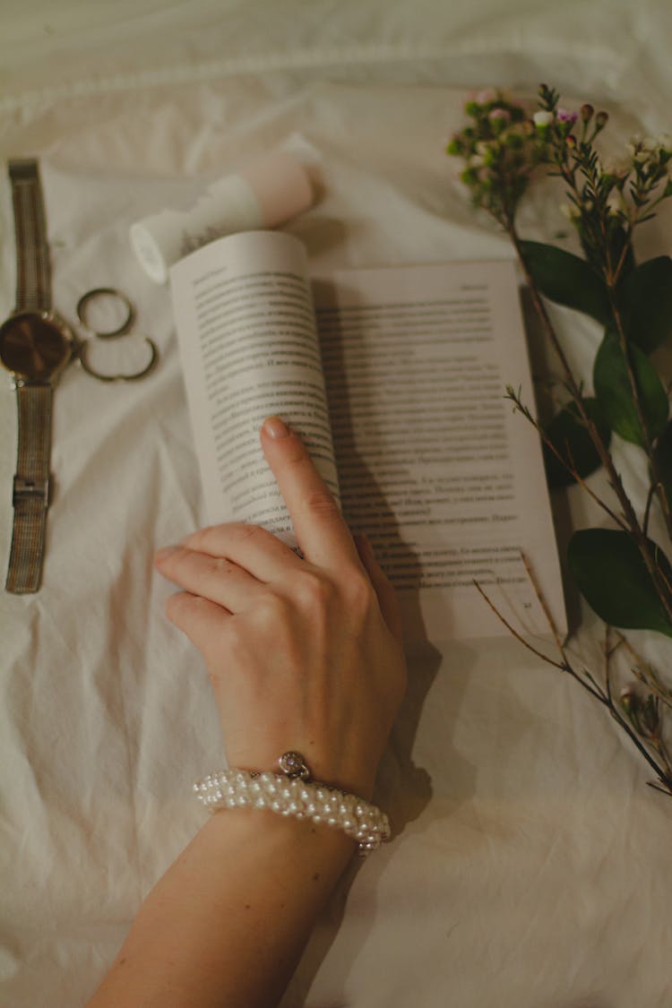 Photo Of A Person's Hand Touching A Book