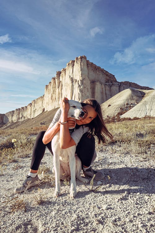 Free Woman Sitting with a White Dog Stock Photo