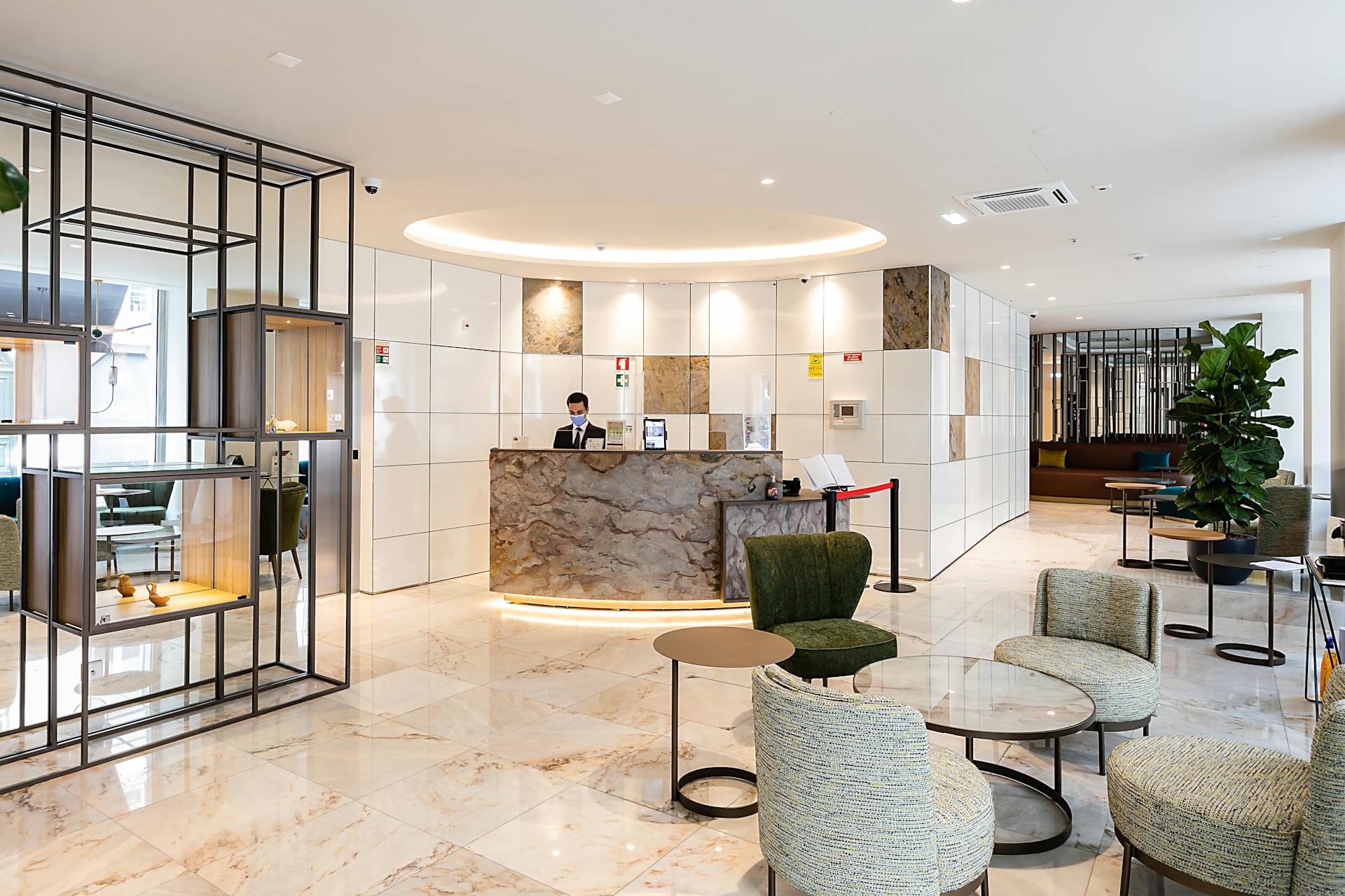 Elegant hotel lobby in Lisbon with stylish interior design and reception desk.