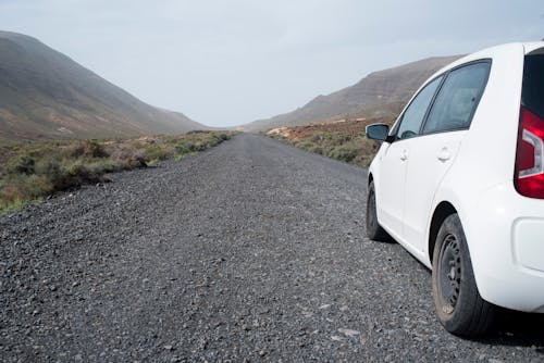 White Car on Gray Dirt Road